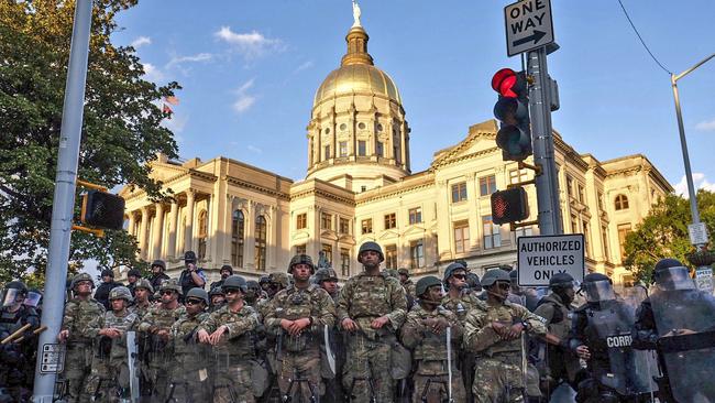 Authorities stand guard in the area around the Georgia state Capitol as protests continued.