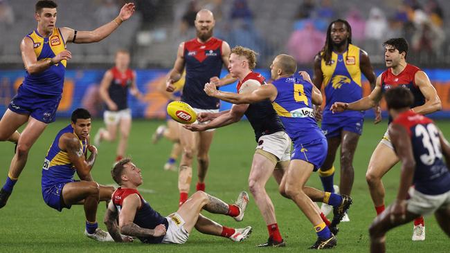 Star Demon Clayton Oliver fires out a handpass in heavy traffic. Picture: Paul Kane/Getty Images