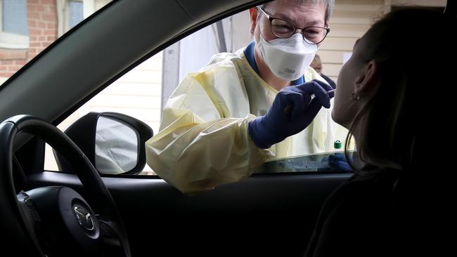 A nurse takes a sample from a driver at a new COVID-19 drive-through testing facility at Hampstead Rehabilitation Centre in Adelaide. Picture: Kelly Barnes