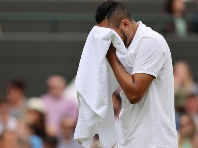 LONDON, ENGLAND - JULY 03: Nick Kyrgios of Australia reacts as he retire's injured during his men's singles third round match against Felix Auger Aliassime of Canada during Day Six of The Championships - Wimbledon 2021 at All England Lawn Tennis and Croquet Club on July 03, 2021 in London, England. (Photo by Clive Brunskill/Getty Images)