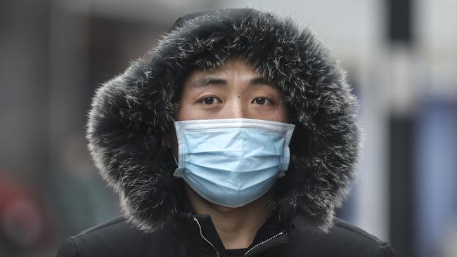 A man wears a mask while walking in the street in Wuhan. Picture: Getty Images