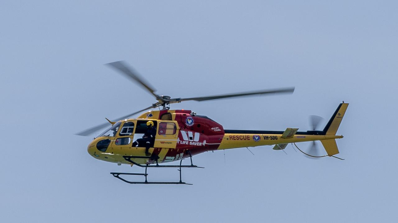 The rescue chopper searches for the shark. Picture: Ben Clark