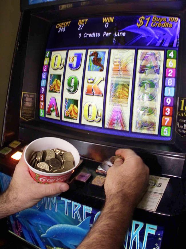 A man plays the pokies. Generic photo.