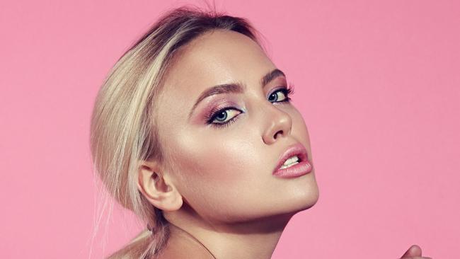 Istock photo for beauty column in Gold Coast Eye Jan 20Sexy bright makeup blond woman posing sitting on the chair in white top on pink background. Toned closeup portrait