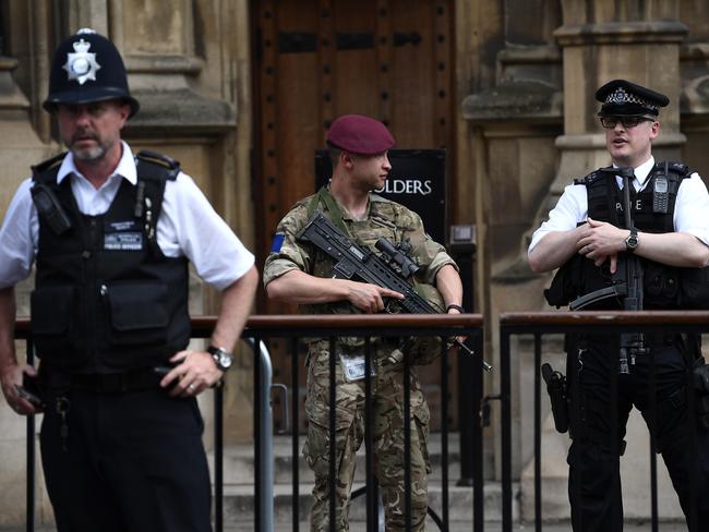 LONDON, ENGLAND - MAY 24:  An armed soldier and an armed police officer stand guard outside the Houses of Parliament on May 24, 2017 in London, England. 984 military personnel are being deployed around the country as the UK terror status is elevated to Critical in the wake of the Manchester Arena Terror Attack which took place on Monday night.   Changing the Guard at the Buckingham Palace was cancelled and The Houses of Parliament have closed to the public.  (Photo by Carl Court/Getty Images)