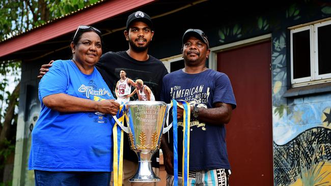 West Coast Eagles premiership player Willie Rioli Jr with the 2018 AFL premiership cup and his parents Georgina and Willie Sr. Picture: Justin Kennedy