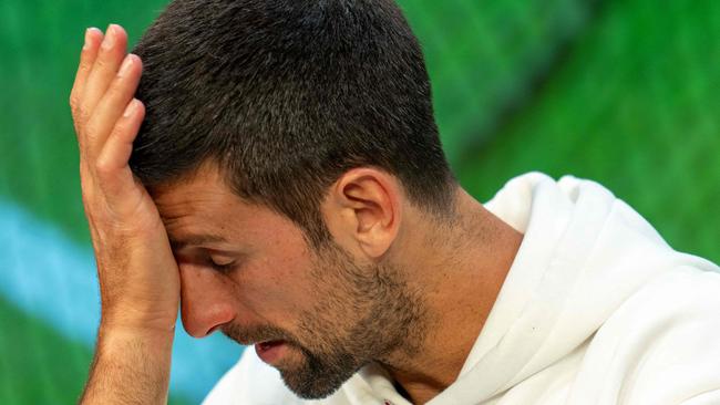 TOPSHOT - Serbia's Novak Djokovic reacts as he speaks during a press conference in the Media Theatre at the Broadcast Centre following his defeat in the men's singles final tennis match against Spain's Carlos Alcaraz on the last day of the 2023 Wimbledon Championships at The All England Tennis Club in Wimbledon, southwest London, on July 16, 2023. (Photo by Joe TOTH / various sources / AFP) / RESTRICTED TO EDITORIAL USE