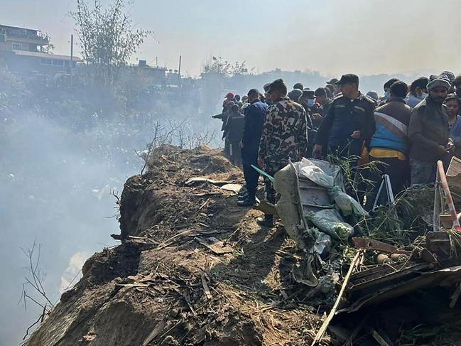 Rescuers and onlookers gather at the site of the plane crash in Pokhara on January 15. Picture: Krishna Mani Baral / AFP