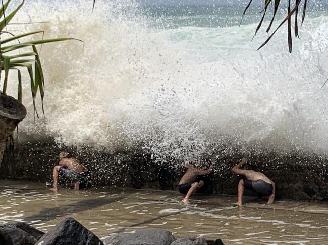 Young kids were spotted playing a dangerous game with the large surf at Froggy's Beach near Snapper Rocks. Picture: Kathleen Skene