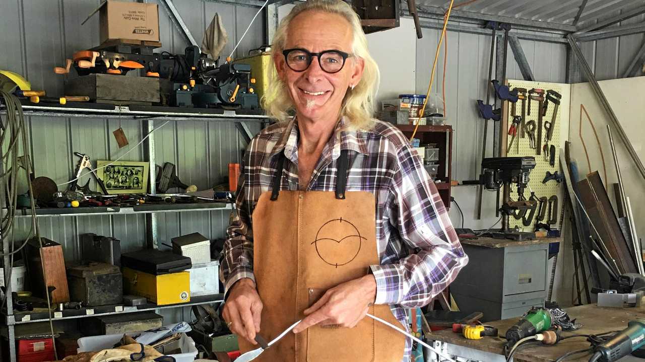 Artist David Sanders working on a one-metre metal piece of art. Picture: Contributed