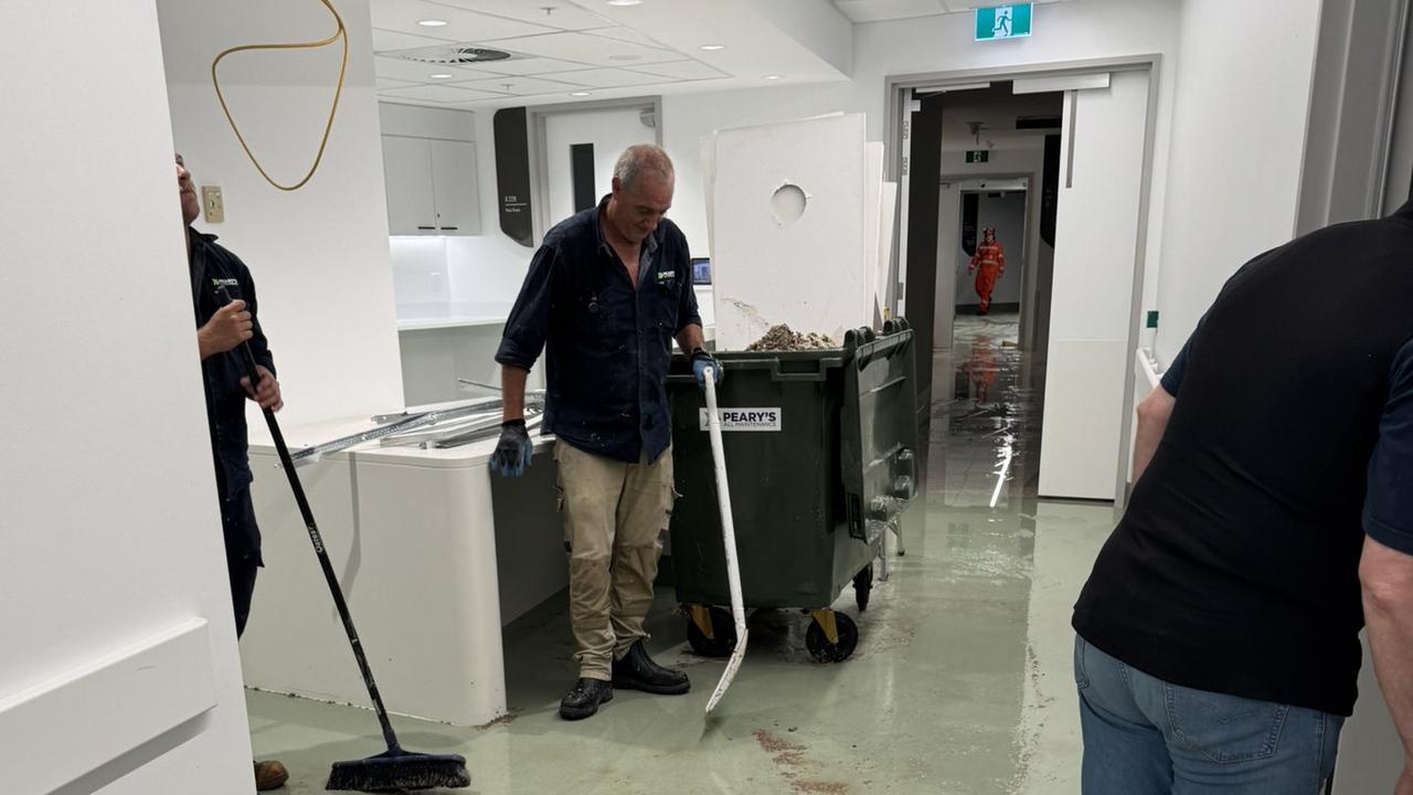 Tradies clean the flooded interior of the Bragg Centre. Picture: X