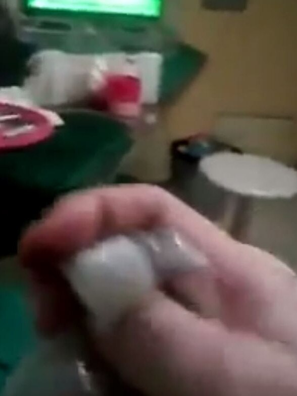 The inmate was filmed holding a bag of the drug ice. Source: YouTube