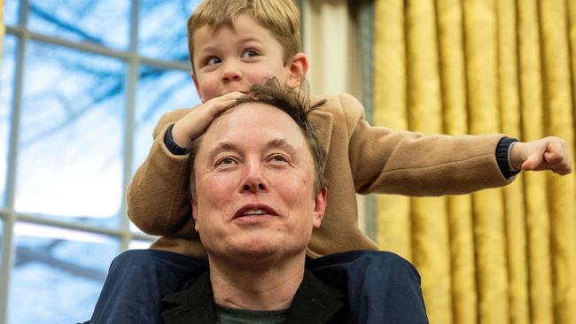 Elon Musk carries his son X on his shoulders while speaking in the Oval Office. Picture; AFP.