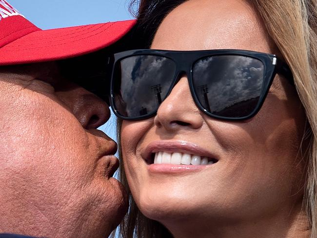 US President Donald Trump kisses US First Lady Melania Trump during a "Make America Great Again" rally at Raymond James Stadium's parking lot on October 29, 2020, in Tampa, Florida. (Photo by Brendan Smialowski / AFP)