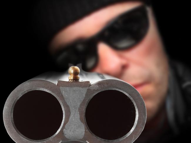 Gangster with shotgun aimed at you. Gun control concept. Close up with shallow DOF.