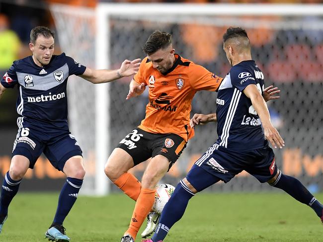 Brisbane Roar’s Jay O'Shea is challenged by Melbourne Victory’s Leigh Broxham (left) and Kristijan Dobras. Picture: Getty Images