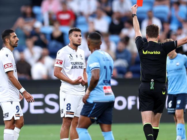 SYDNEY, AUSTRALIA - DECEMBER 28: Zinedine Machach of the Victory is shown a red card from Referee Adam Kersey during the round 10 A-League Men match between Sydney FC and Melbourne Victory at Allianz Stadium, on December 28, 2024, in Sydney, Australia. (Photo by Brendon Thorne/Getty Images)