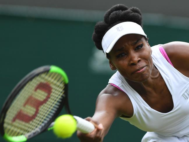 Venus Williams flashing too much pink bra strap for official’s liking. Picture: Glyn Kirk/AFP