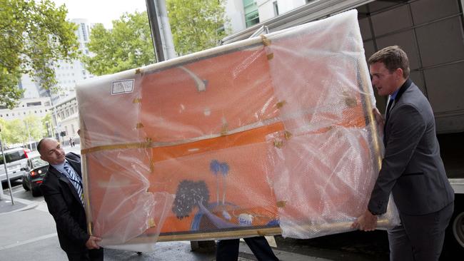 Detectives carry one of the allegedly fake Brett Whiteley paintings into court. Picture: Nathan Dyer