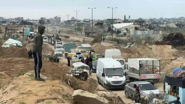 Palestinians cross the Netzarim Corridor as they make their way to the north of Gaza