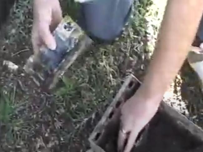 Police recover cash canisters from the Cooks River on August 21, 2009