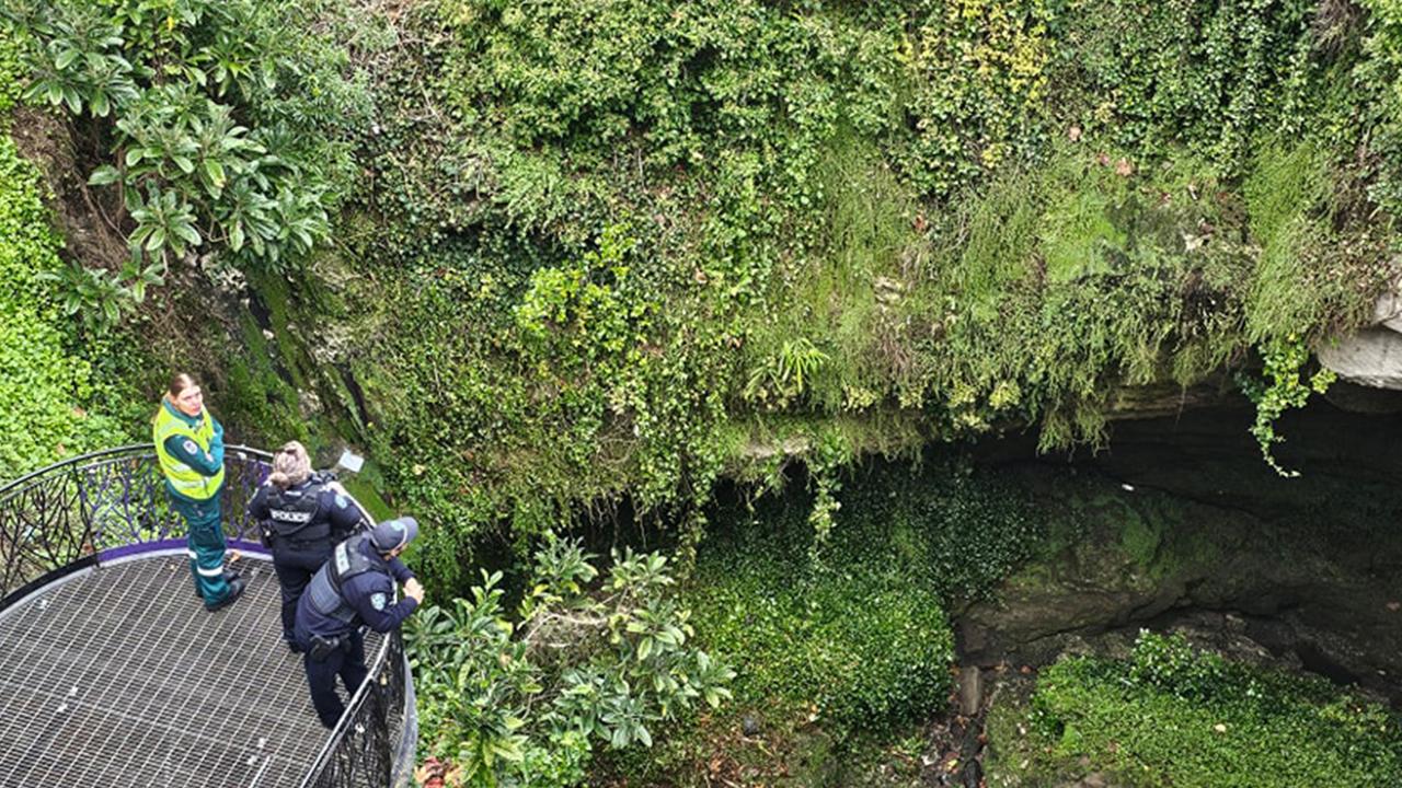 Rescuers work to free man trapped in sinkhole