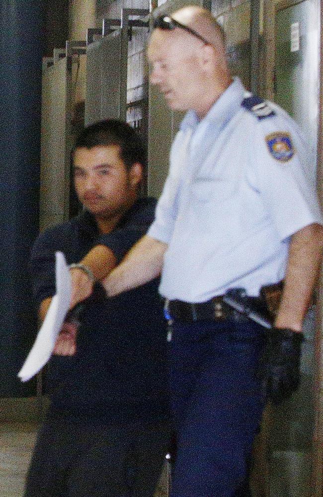 Murder accused Joel Robertson is lead out of Burwood court to a prison truck. Picture: John Appleyard