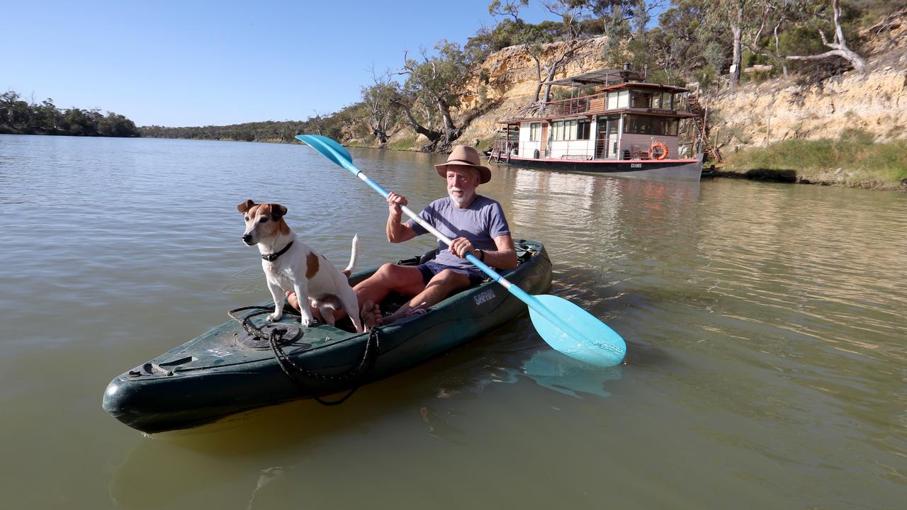 Rex Ellis, with his dog Bill in the Murray River near Morgan. Picture: David Geraghty/The Australian