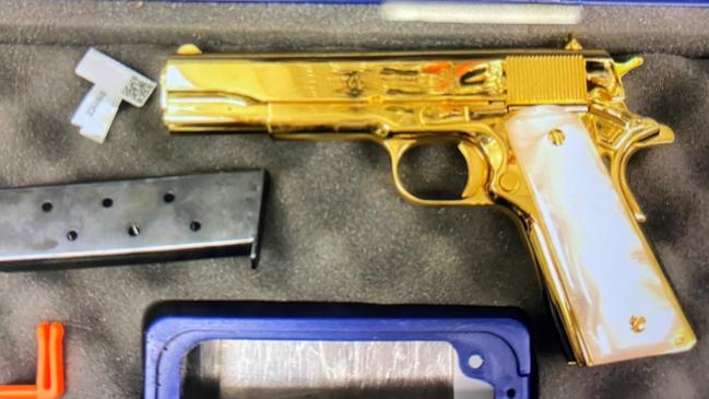 Authorities allege the weapon is a custom 1911 Colt 45 plated in 24-karat gold.