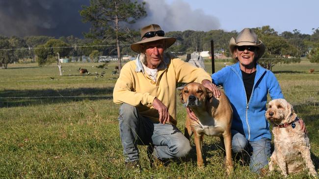 Richard Green and Pam Cox watch from their farm as emergency services fight to control a bushfire at Peregian last month.