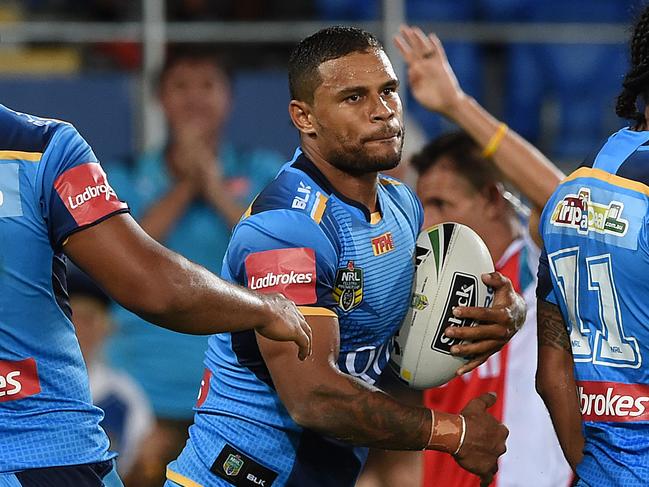 Titans player Josh Hoffman (centre) looks on after scoring a try during the Round 3 NRL match between the Gold Coast Titans and the West Tigers at CBUS Stadium on the Gold Coast, Saturday, March 19, 2016. (AAP Image/Dave Hunt) NO ARCHIVING, EDITORIAL USE ONLY