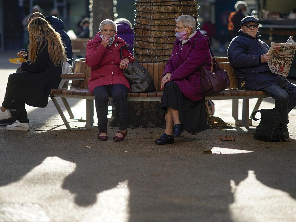 People relax in the afternoon sunshine in Coventry, England. Boris Johnson is implementing tougher regional rules. Picture: Christopher Furlong/Getty Images