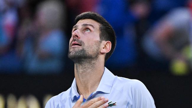 Serbia's Novak Djokovic celebrates after victory against USA's Taylor Fritz during their men's singles quarter-final match on day 10 of the Australian Open tennis tournament in Melbourne on January 23, 2024. (Photo by WILLIAM WEST / AFP) / -- IMAGE RESTRICTED TO EDITORIAL USE - STRICTLY NO COMMERCIAL USE --