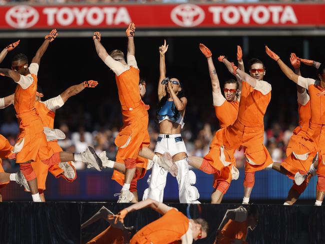 A crew of orange men dance with Perry on stage. Picture: Phil Hillyard