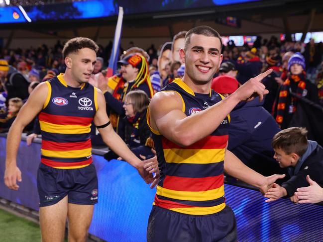 Josh Rachele celebrates the Crows’ win over GWS with fans. Picture: Sarah Reed/AFL Photos via Getty Images.