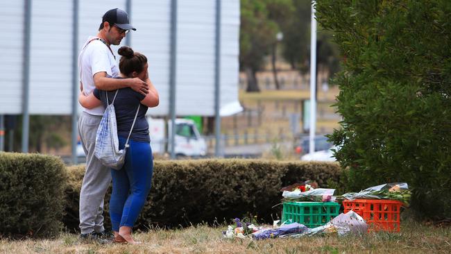 A couple lay flowers at the site where Aiia Maasarwe was found dead. Picture: Aaron Francis