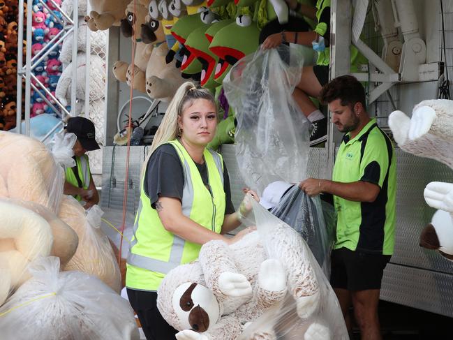 Savanah Fisher, 25, packing up the games in Sideshow Alley after the Ekka was cancelled due to COVID-19. Picture: Liam Kidston.