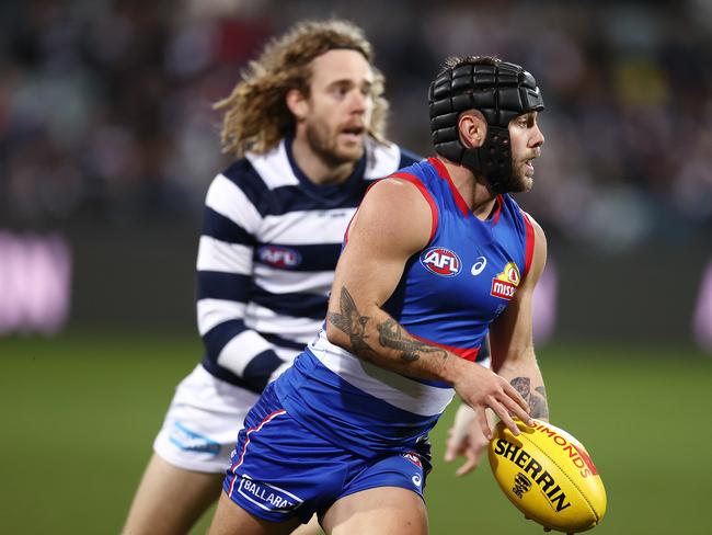 AFL Round 14. Geelong vs Western Bulldogs at GMHBA Stadium, Geelong. 18/06/2021.  Bulldog Caleb Daniel clears infant of Cameron Guthrie of the Cats during the 2nd qtr.    .  Pic: Michael Klein