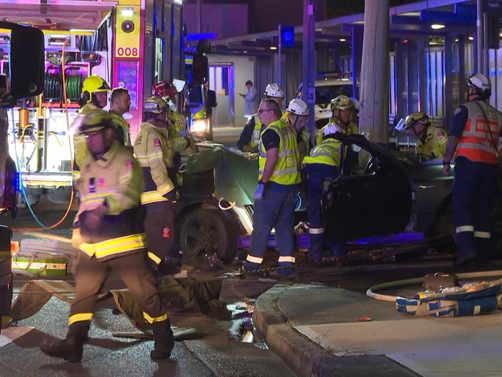 Pictured are emergency services attending a car crash after a Police pursuit on Railway Parade, Canley Vale when the vehicle being pursued lost control and hit a telegraph pole trapping two people. Picture: TNV