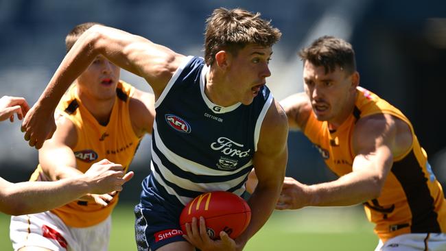 Connor O'Sullivan goes to handball against Hawthorn in a recent practice match. Picture: Quinn Rooney/Getty Images.