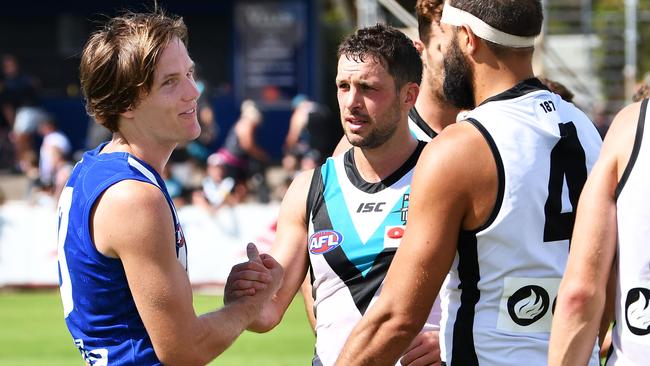 Jared Polec of the Kangaroos with old teammates Travis Boak and Paddy Ryder of Port Adelaide after Saturday’s JLT Community Series AFL match. Picture: Getty Images