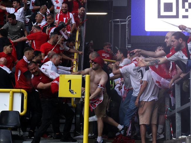 DORTMUND, GERMANY - JUNE 18: Fans of Turkiye and Georgia clash in the stands prior to the UEFA EURO 2024 group stage match between Turkiye and Georgia at Football Stadium Dortmund on June 18, 2024 in Dortmund, Germany. (Photo by Dean Mouhtaropoulos/Getty Images)