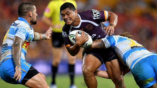 Anthony Milford runs the ball for the Broncos against the Titans.