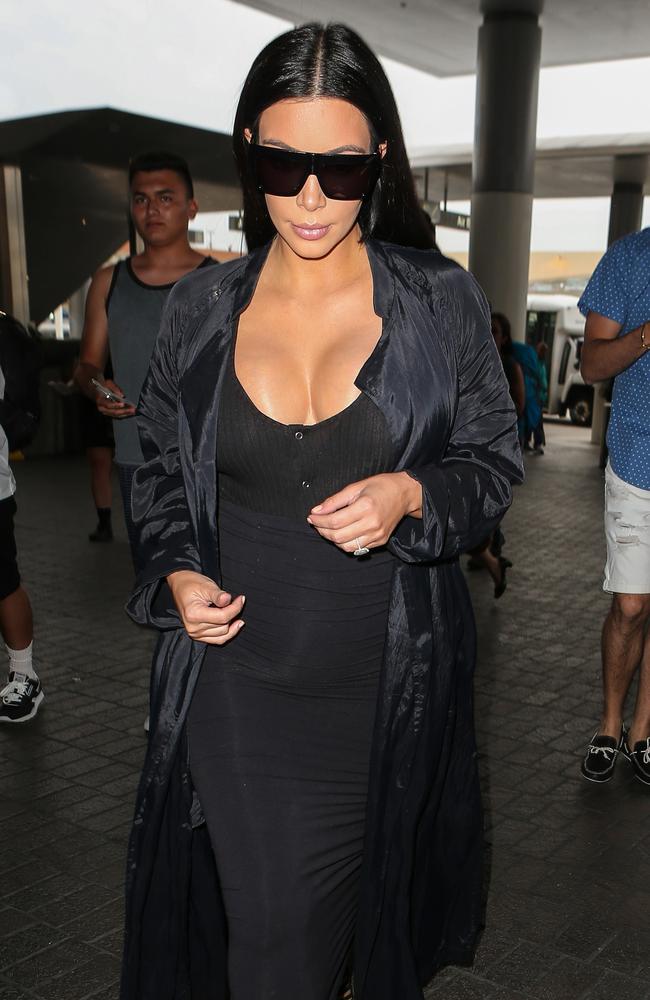 There is no taming Kim Kardashian’s growing curves as she rocks an ultra-tight frock on July 19, 2015 at LAX. Picture: Splash