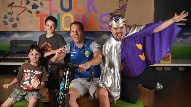 Danish and English premier league goalkeeping legend Thomas Sorensen is farewelled by brothers Hayden and Anthony Stringer (9) and Captain Starlight in the Starlight Express Room at the Women's and Children's Hospital on Tuesday. Picture: Naomi Jellicoe