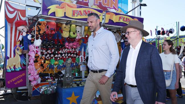 Labor Party candidate for Leichhardt Matt Smith and Australian Prime Minister Anthony Albanese walk through sideshow alley together on the final day of the Cairns Show. Picture: Brendan Radke