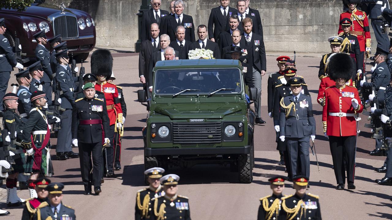 Prince William, left and Prince Harry, right, with members of the royal family behind the Duke of Edinburgh’s coffin inside the Land Rover last Saturday. Picture: Eddie Mulholland/Getty Images