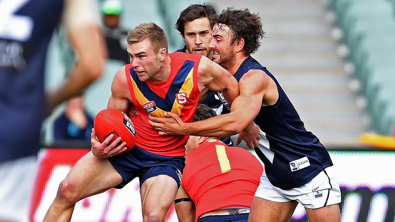 South Australia’s Andrew Bradley is tackled by Victoria’s Willie Wheeler in the last interstate clash between the SANFL and VFL at Adelaide Oval in 2016. Photo Tom Huntley