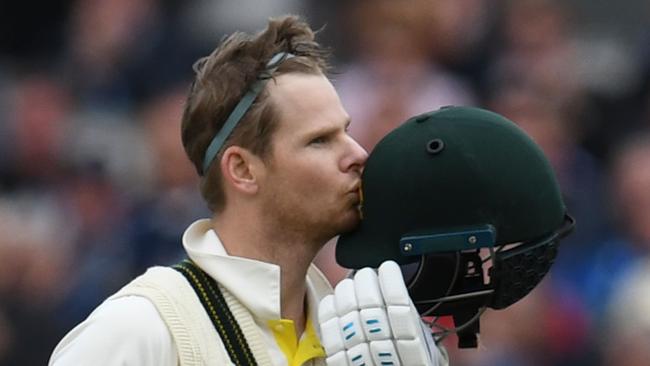 Australia's Steve Smith kisses the badge on his helmet as he celebrates making 100 runs on the second day of the fourth Ashes cricket Test match between England and Australia at Old Trafford in Manchester, northwest England on September 5, 2019. (Photo by Paul ELLIS / AFP) / RESTRICTED TO EDITORIAL USE. NO ASSOCIATION WITH DIRECT COMPETITOR OF SPONSOR, PARTNER, OR SUPPLIER OF THE ECB