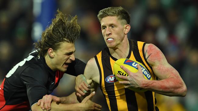 LAUNCESTON, AUSTRALIA - JUNE 20: Sam Frost of the Hawks is tackled by Harrison Jones of the Bombers during the round 14 AFL match between the Hawthorn Hawks and the Essendon Bombers at University of Tasmania Stadium on June 20, 2021 in Launceston, Australia. (Photo by Steve Bell/Getty Images)